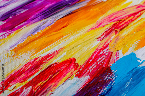 Beautiful strokes of colorful oil paints on white canvas as background, closeup