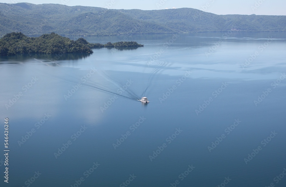 A sightseeing boat cruising around Lake Towada in Japan - from a observation deck view