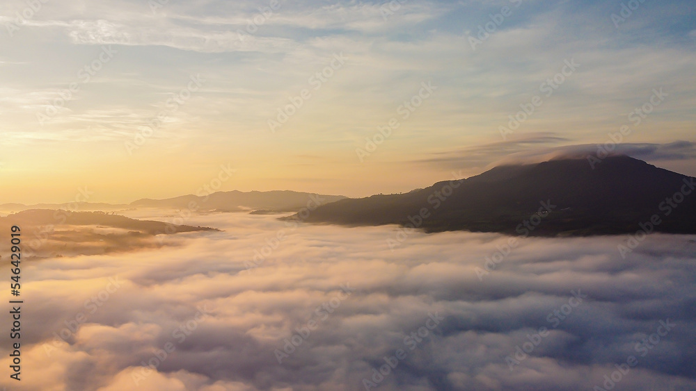 Thick fog in the mountains at dawn, Beautiful  sunrise and fog landscape.