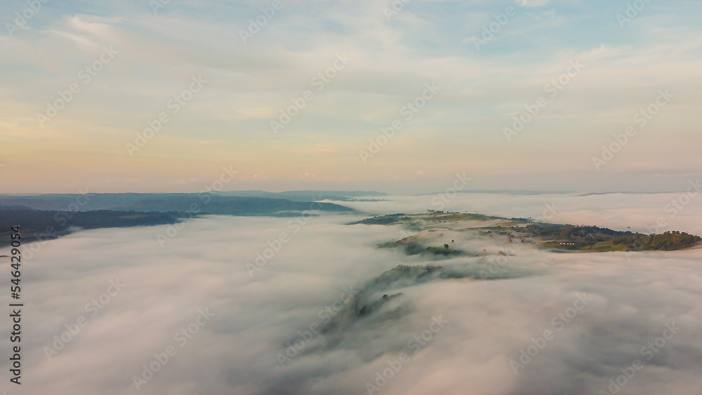 Beautiful aerial view with sunrise over the mountain in morning and thick mist.