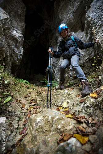 Speleologist Woman Descending on Slippery Slope out of a Cave