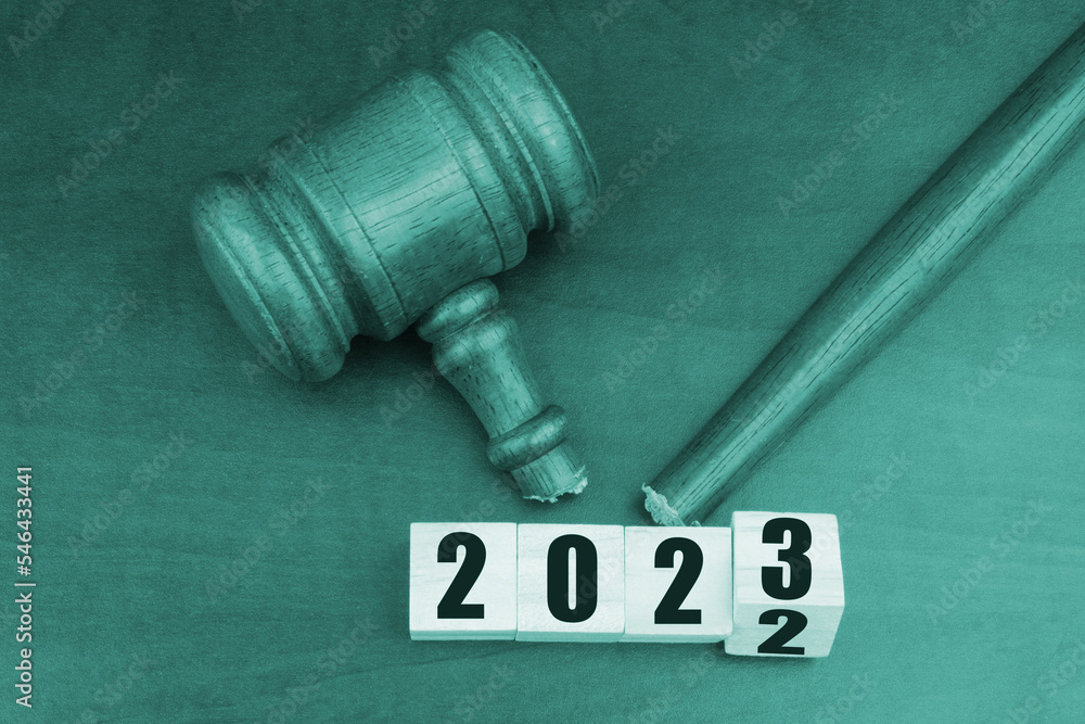 Injustice and lawlessness in 2023. Broken judge gavel and numbers 2023 on wooden table.