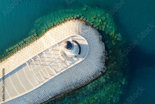 Amazing aerial view of lighthouse and dam on Lustica bay near Tivat, Montenegro on sunny day. photo