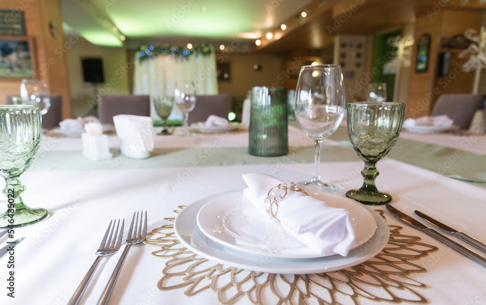 Serving and decoration of the wedding table. Glasses, spoons, forks and white napkins
Serving and decoration of the wedding table. Glasses, spoons, forks and white napkins