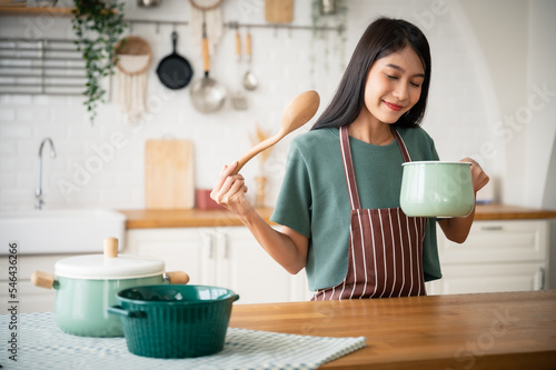 Young beauty asian woman cooking in kitchen room at home photo
