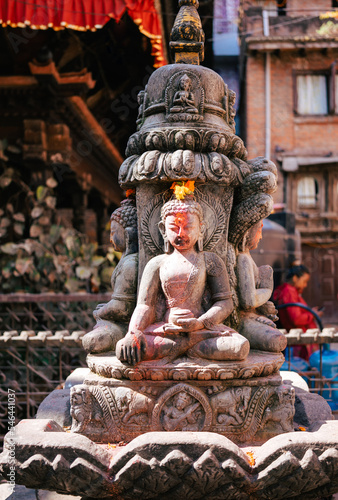 Tableau sur toile Buddhist statue with Holy paint on a sunny day in the old town of Kathmandu Nepal