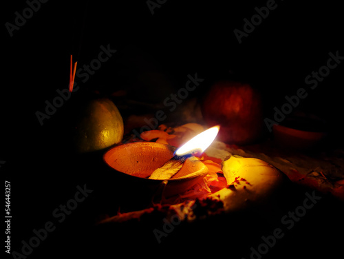 Burning oil lamp on Hindu rituals, Hindu devotee offer Prasad, fruits, vegetables and other items and light lamp or diya for prayer. photo