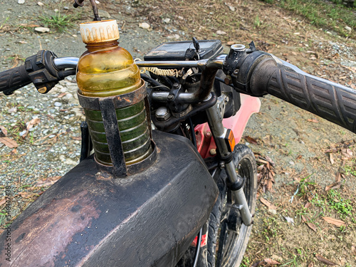 an old motorbike with a modified gas tank using an old bottle