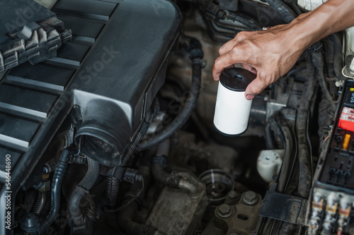 Auto mechanic replacing DSG transmission oil filler. photo