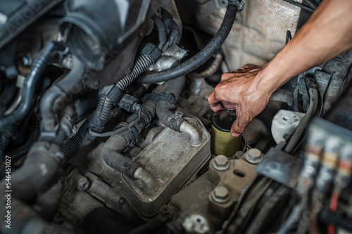 Auto mechanic changing DSG transmission oil filler.