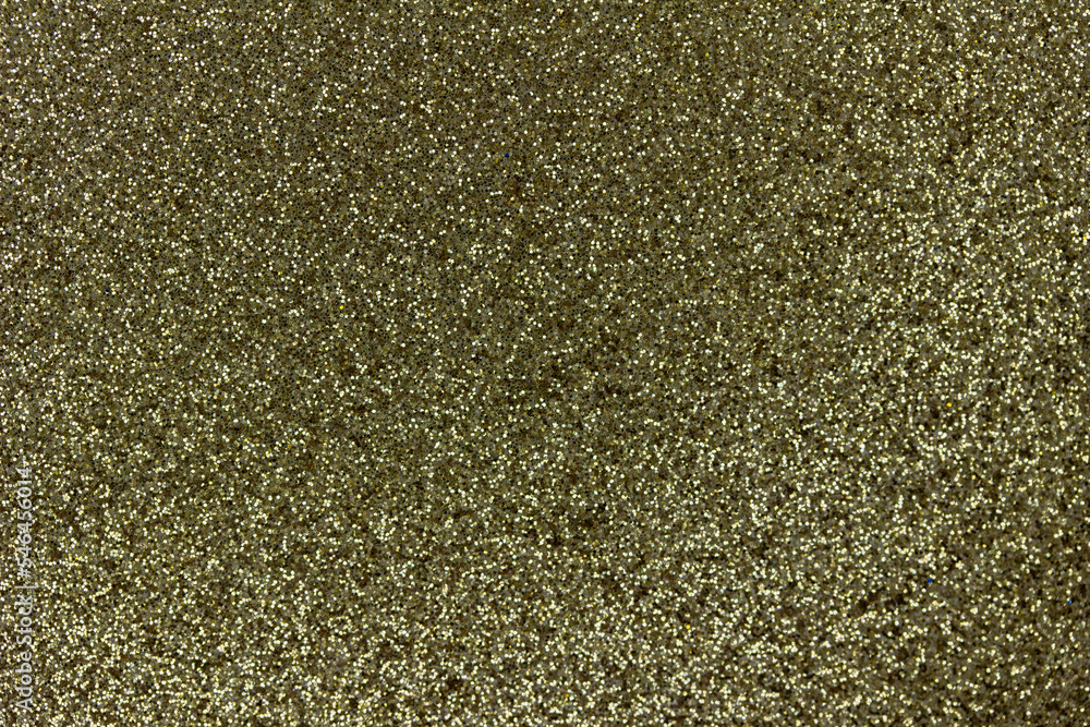 Macro image of a sparkling gold color glitter texture background Macro image of a sparkling gold color glitter texture background