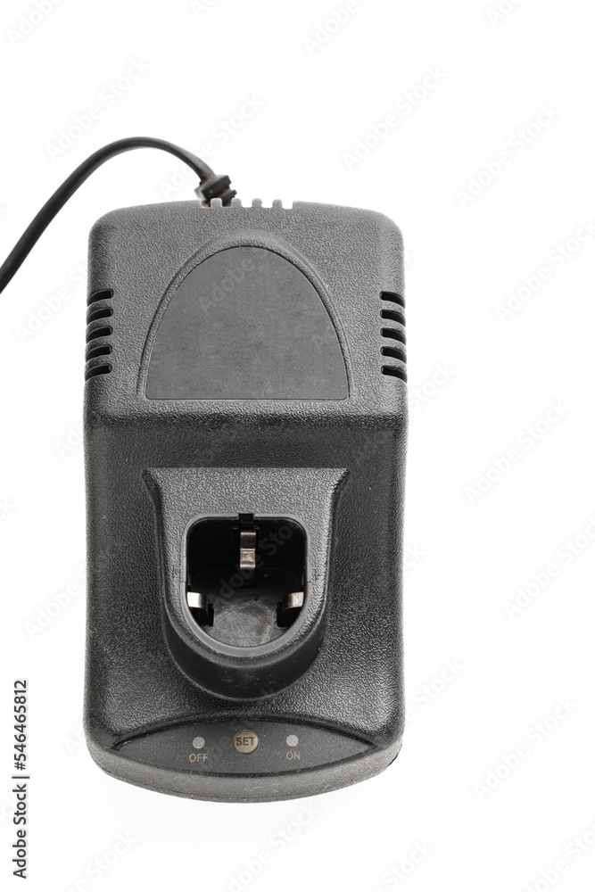 Charger for screwdriver on a white background. Accessory for energy replenishment, constant power supply of battery-powered models. Charger for screwdriver on a white background. Accessory for energy replenishment, constant power supply of battery-powered models.