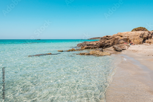 Elafonisi, crete island, greece: pink colored sandy beach with black rocks at the famous cretan lagoon