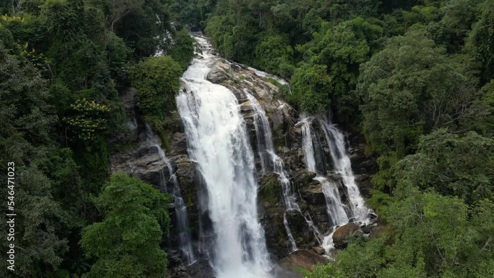 Slow aerial forward flight over beautiful hidden waterfall in lush jungle Slow aerial forward flight over beautiful hidden waterfall in lush jungle