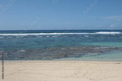 Beach with white sand, blue sky, and blue ocean on a sunny day (ID: 546477467)