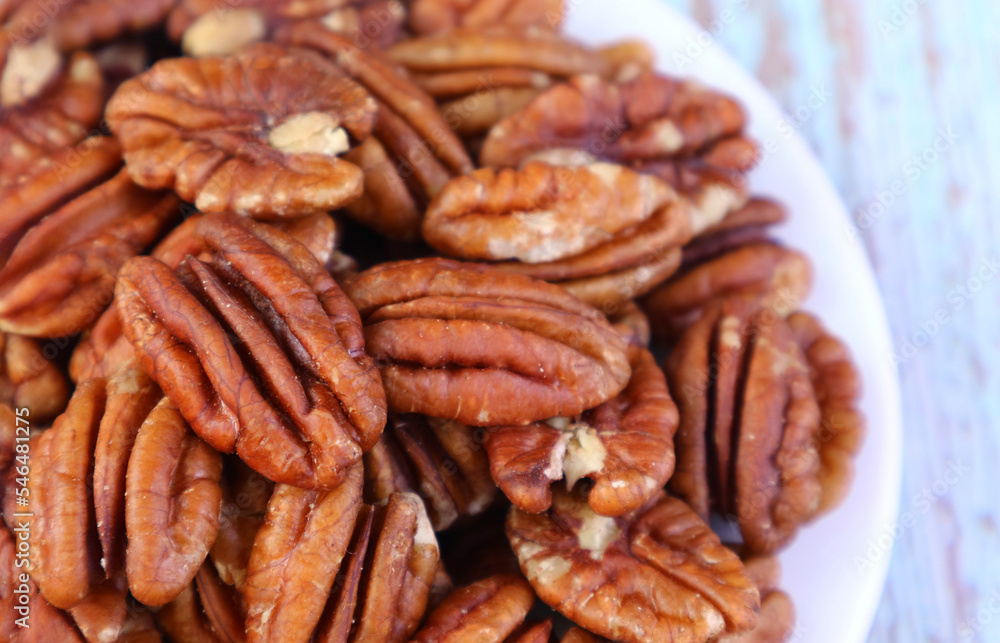 Closeup of Pile of Pecan Nuts on a White Plate Closeup of Pile of Pecan Nuts on a White Plate