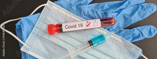 Positive covid-19 test test tube with blood medical mask and glove