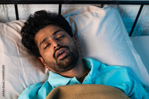 Photography close up shot of man sleeping by snoring with mouth open during night - concept