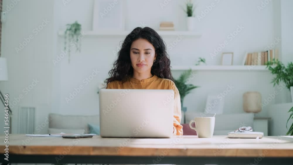 Video of beautiful business woman working with laptop in living room at home. Video of beautiful business woman working with laptop in living room at home.