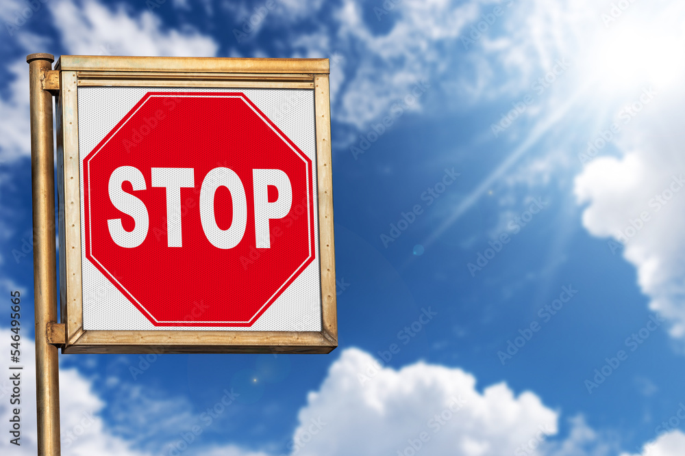 Obraz premium Close-up of a stop road sign against a clear blue sky with clouds and sunbeams, photography.