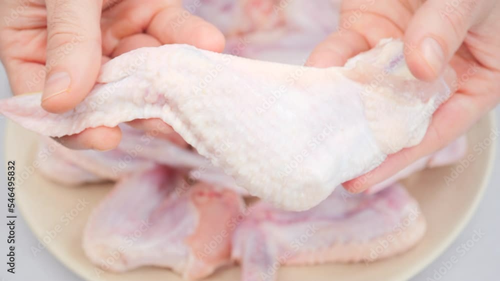 Raw chicken leg in chef hands