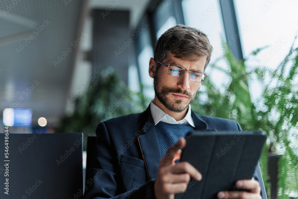 business man using a digital tablet during a business trip.