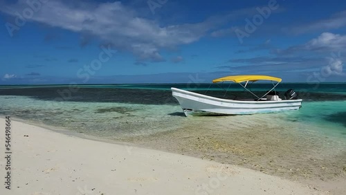 MOTOR BOAT MOORED AT CARRIBBEAN BEACH, SAQUI SAQUI ISLAND LOS ROQUES, STATIC SHOT photo