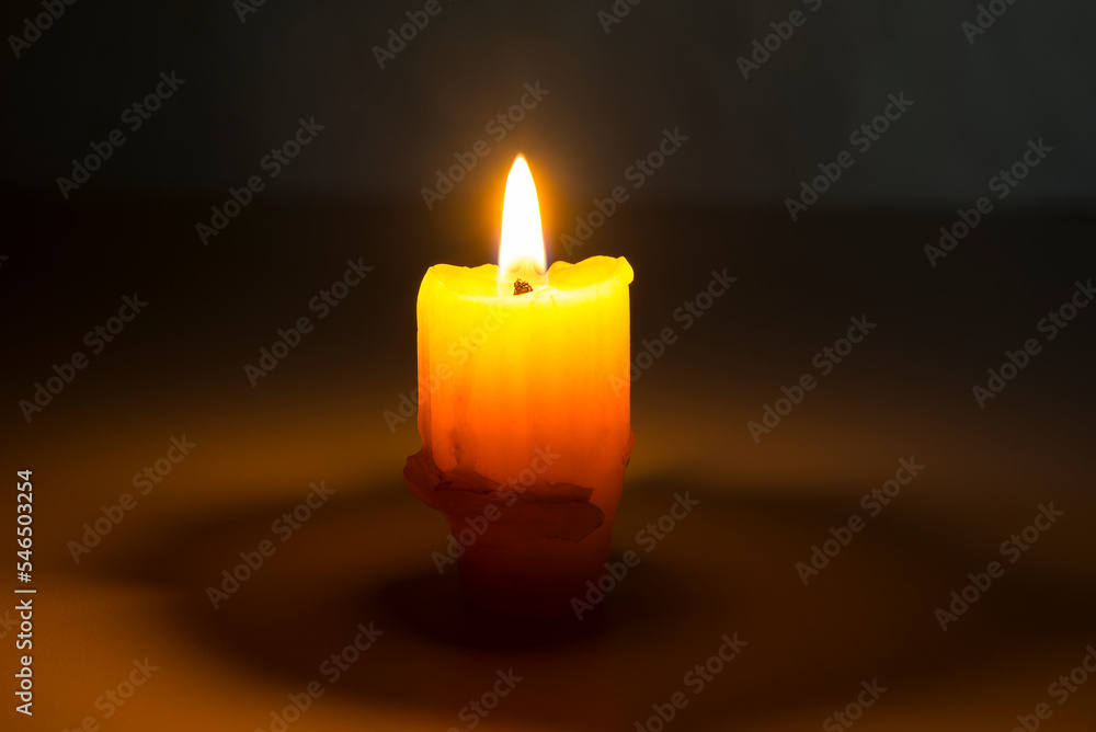 Old burning candle with a flame. Melted wax Old burning candle with a flame. Melted wax