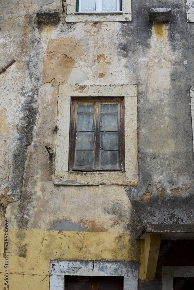 Antique window on an old wall