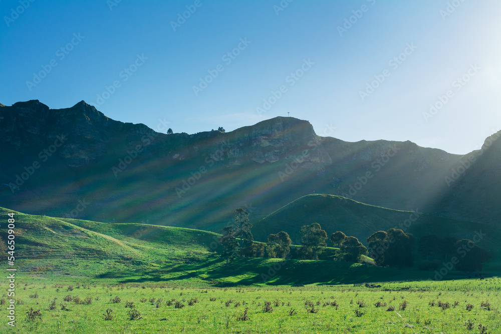 Setting sun casting long shadows accross green valley. Majestic ridge of Te Mata rising under clear blue sky. Breathtaking veiw of Hawke's Bay region, New Zealand