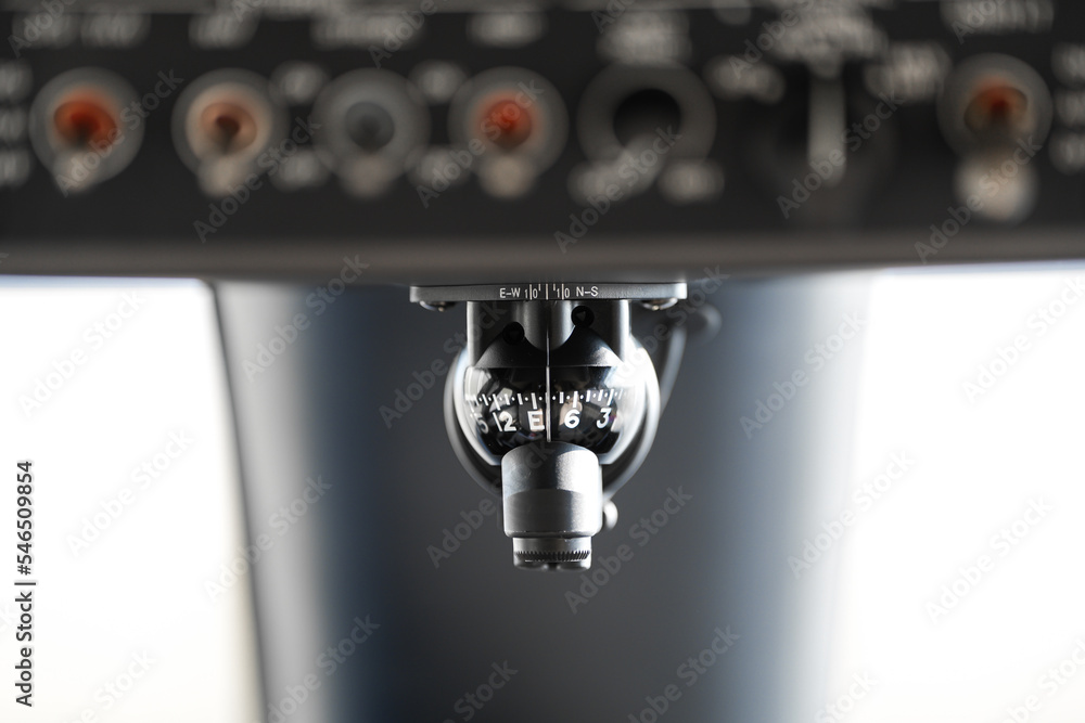 Compass in the cockpit of an airplane. Dashboard orientation tools ...