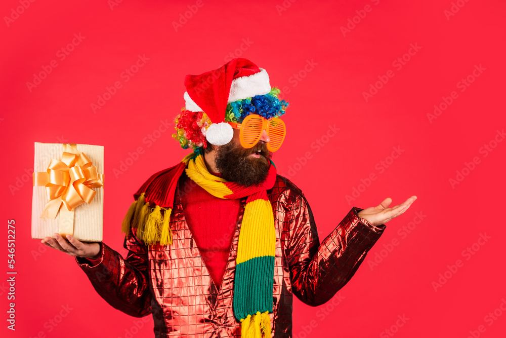 surprised bearded man in sweater. gifts and presents preparation. surprise for xmas holiday. its christmas time. new year party. mature and brutal hipster in santa claus hat. copy space