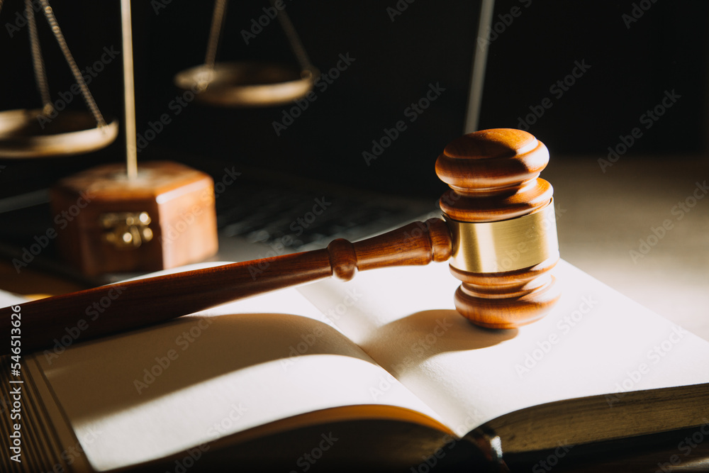 Business and lawyers discussing contract papers with brass scale on desk in office. Law, legal services, advice, justice and law concept picture with film grain effect Business and lawyers discussing contract papers with brass scale on desk in office. Law, legal services, advice, justice and law concept picture with film grain effect