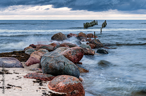 Late autumn coastal landscape with old broken pier and migrating ducks, long ...