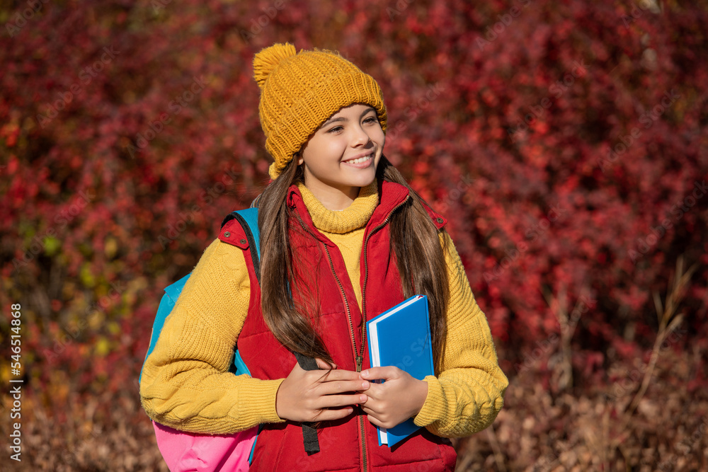 cheerful girl pupil back to school in autumn