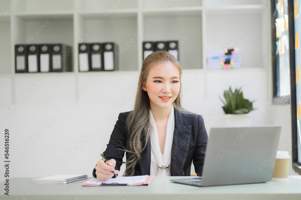 business woman or accountant who are using a calculator to calculate business data Accounting documents and laptop computer at the office business idea business woman or accountant who are using a calculator to calculate business data Accounting documents and laptop computer at the office business idea