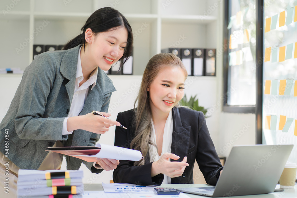Obraz premium Portrait of Asian young female working on laptop at office