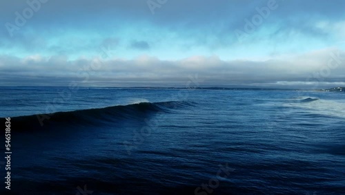 A drone shot of a waves coming to a crash on larencetown beach east coast of Canada. shot was taken early morning taken off from the cliffs and flying as low to the water as possible to take the shot. photo