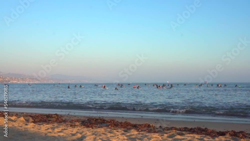 Surfers and people enjoying the water at Laguna Beach, CA photo