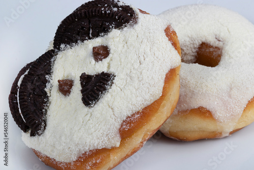 Sweet donuts with cream and powdered milk frosting and another fun bear themed donut. Close-up photography .