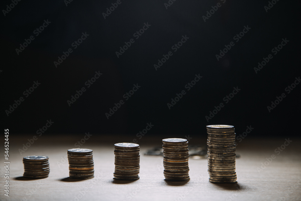 business woman hand calculating her money in the end of month with coin, calculator and calendar on wooden table business woman hand calculating her money in the end of month with coin, calculator and calendar on wooden table