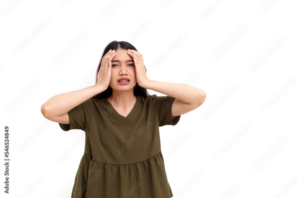 Stressed beautiful young asian woman standing while holding her head. Woman suffering from headache. Isolated on white Stressed beautiful young asian woman standing while holding her head. Woman suffering from headache. Isolated on white