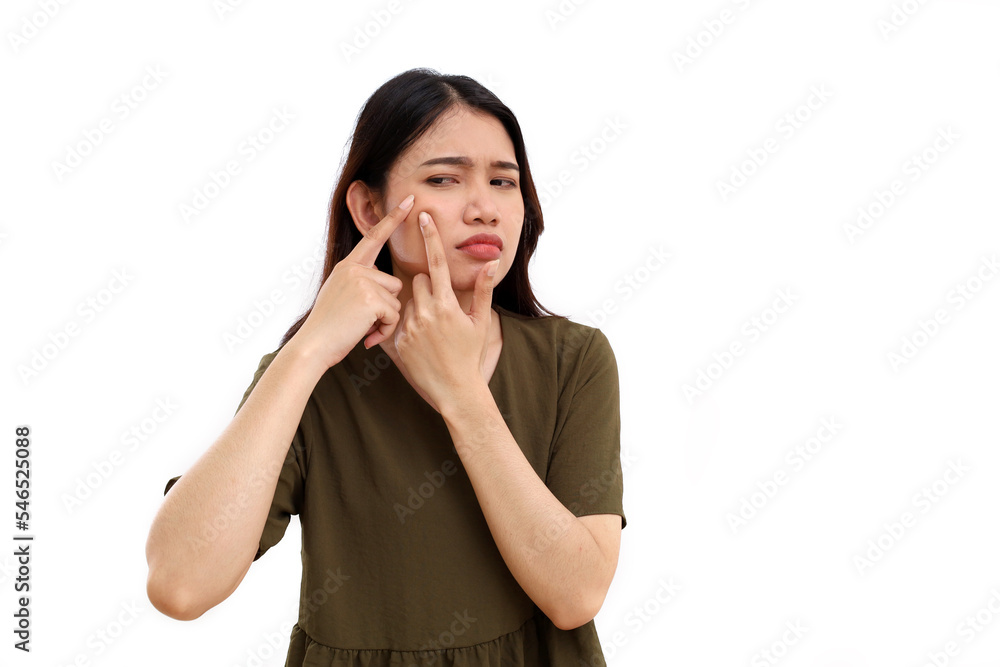 Unhappy young asian woman with pimple on his cheek. Isolated on white with copyspace Unhappy young asian woman with pimple on his cheek. Isolated on white with copyspace