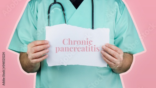 Chronic pancreatitis. Doctor with stethoscope in turquoise coat holds note with medical term. photo