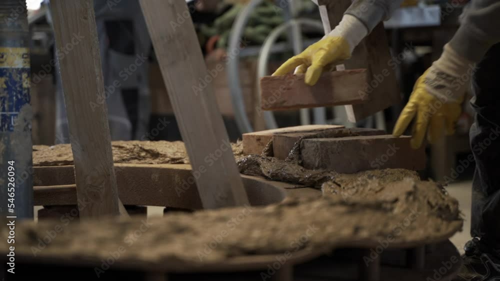 Bricklayer Laying Bricks on Clay Mixture, Building Bell Casting Mold.