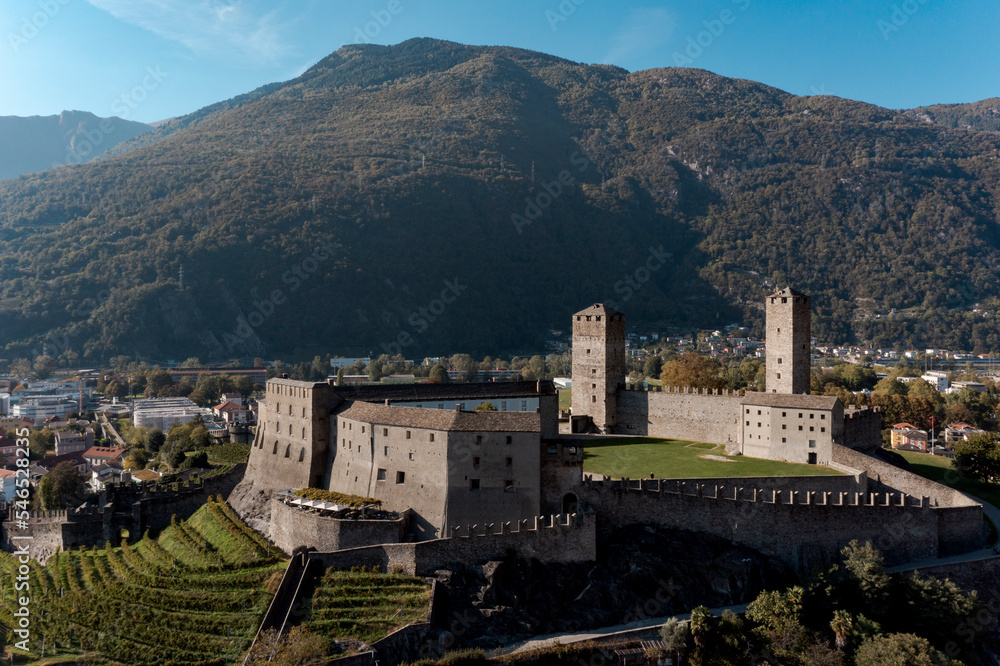 Obraz premium Aerial view of Bellinzona Castle atop the Swiss Alps taken from a drone on a sunny day. Fantastic view