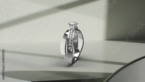 Elegant Rotating Diamond Ring
A ring with a large solitaire on a gray background and surrounded by small diamonds.