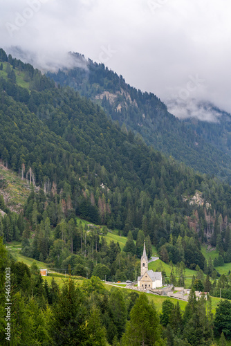 A lonely church at the foot of a forrest mountain in alps, Sauris, Italy