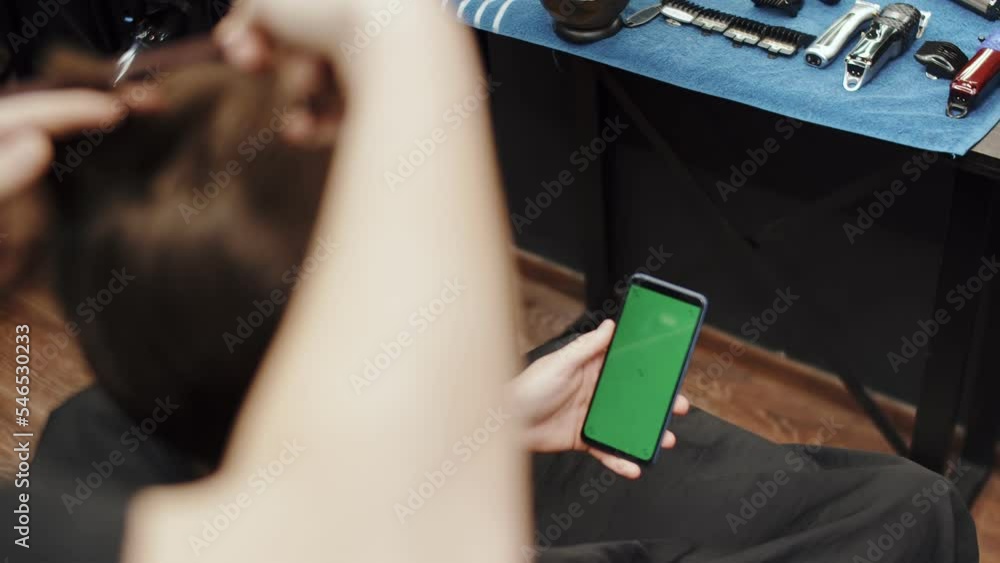 Close up Male Client watching at the smartphone green screen mockup ...