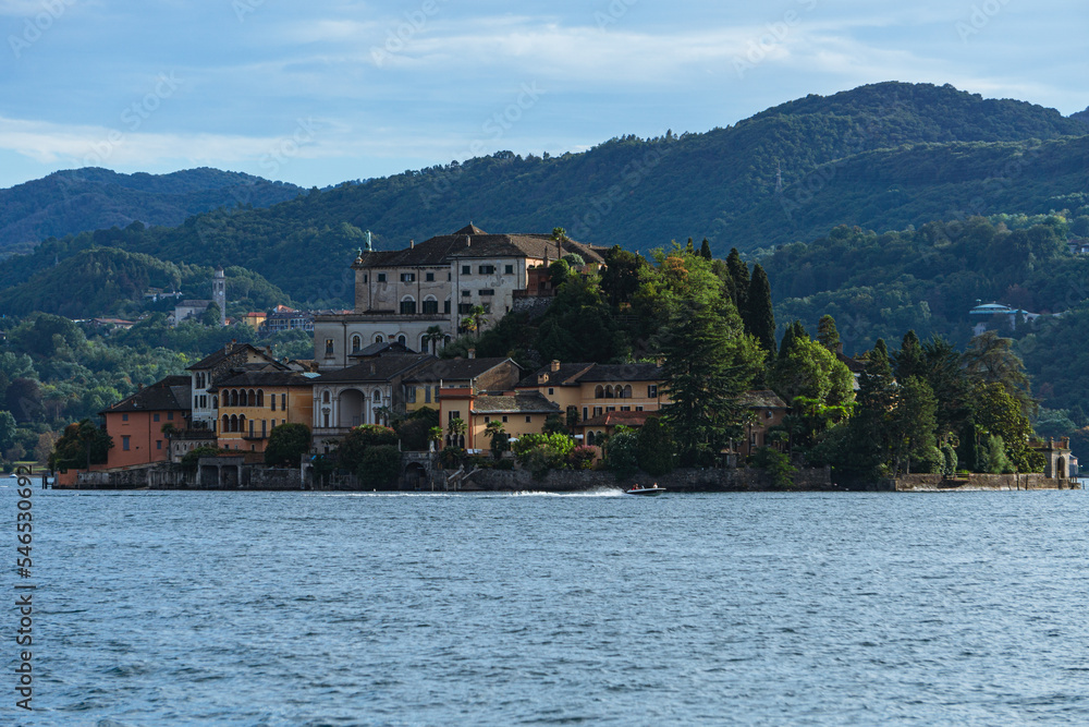 Lake orta and the island of san giulio, an important tourist destination in piedmont, seen during a summer day from the town of Orta San Giulio, Italy - August 2022.